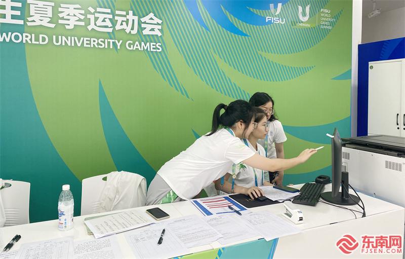 在成都大运会射击主赛场志愿服务台，志愿者们在核对赛事信息 东南网记者郑晓丹 摄.jpg